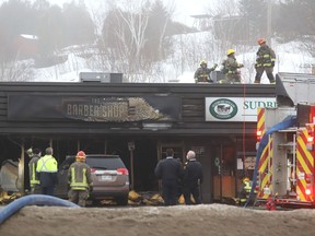 Greater Sudbury firefighters battle a fire at The Barber Shop located in the Eddies Restaurant strip mall on Regent Street early Wednesday.