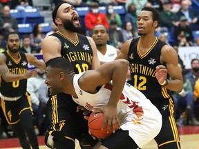 Zena Edosomwan of the Sudbury Five collides with Cameron Forte of the London Lightning during a basketball game at the Sudbury Community Arena in Sudbury, Ont. Thursday, March 17, 2022. John Lappa/Sudbury Star/Postmedia Network