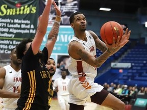 Sudbury Five's Josiah Moore, right, heads for the basket against London Lightning's Jermaine Haley Jr. during a basketball game at the Sudbury Community Arena in Sudbury, Ont. Thursday, March 17, 2022. John Lappa/Sudbury Star/Postmedia Network