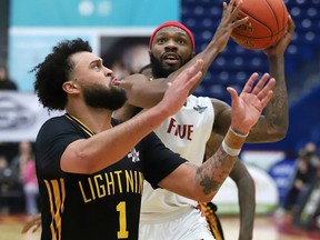 Sudbury Five's Dexter Williams Jr., right, heads for the basket against London Lightning's Jermaine Haley Jr. during a basketball game at the Sudbury Community Arena in Sudbury, Ont.  Thursday, March 17, 2022. John Lappa/Sudbury Star/Postmedia Network