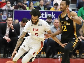 Sudbury Five's Jeremy Harris, left, heads for the basket against London Lightning's Mareik Isom during a basketball game at the Sudbury Community Arena in Sudbury, Ont. Thursday, March 17, 2022. John Lappa/Sudbury Star/Postmedia Network