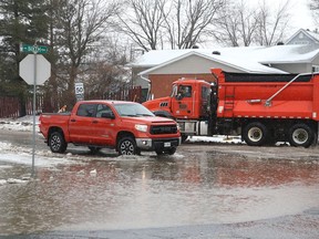 A large puddle partially covers Sixth Avenue in Lively, Ont. on Thursday March 31, 2022. John Lappa/Sudbury Star/Postmedia Network