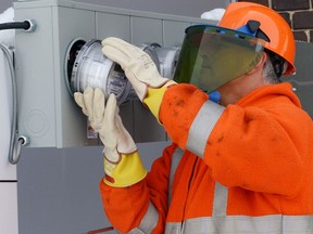 A worker installs a new residential advanced meter, similar to what will be used in Greater Sudbury's smart meter program.