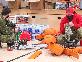 A member of the Canadian Armed Forces and a Canadian Ranger organize emergency supplies for distribution  in Deer Lake First Nation near Kenora.

Supplied