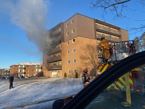 Smoke and fire were coming out of a fourth-floor apartment unit when firefighters arrived at 195 Lisgar Avenue Tuesday morning.  (Submitted)
