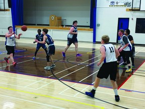 Hawk Ethan Warren passes the basketball during the senior boys' basketball team's game March 3 against Fort Macleod's F.P. Walshe School at the Cultural-Recreational Centre. The Hawks lost the contest 75-56.