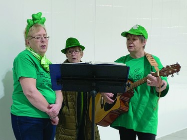 Jan Fraser, Judy Sanderson and Laurie Lyckman sing Irish songs on St. Patrick's Day at the Carmangay Curling Club. The curling club hosted people who had walked that morning in the village's one-block St. Patrick's Day parade. The Grange Hotel had traditionally hosted St. Patrick's Day revellers after the parade, but the hotel, built in 1909, was destroyed by a fire on March 28, 2021.
