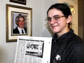 Wallaceburg and District Museum curator Kaelyn Gregory holds a column by local historian, the late Al Mann, (seen in photo) detailing the history of Gloucester Place, located at 315 Elgin St. in Wallaceburg. Three people died in a fire that raced through the house on Feb. 17.  Ellwood Shreve/Postmedia