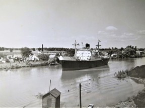 Manchester Explorer, Outbound Wallaceburg, on Aug. 13, 1952. This photo was taken from the east bank of the Sydenham River in the vicinity of the former Canada and Dominion Sugar Co. factory. On the west bank of the river (from left to right) are houses along Old Glass Road between Brabaw Street and the southern boundary of the former Libbey Canada Glass Co. (ex-Dominion Glass Co.) factory. Photo submitted by Blake Mann