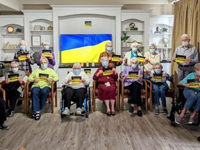 Residents of Metcalfe Gardens gather for a prayer vigil for peace in Ukraine. "It was a very emotional experience for our residents and staff," Rhonda Kaplanis says. "Our seniors understand the devastation the Ukrainians are witnessing." The vigil was one of a number of ways the community is showing support for the invaded country. (Contributed)