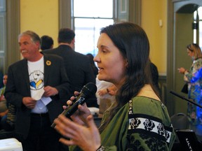 Petrusia Hontar speaks to a sold-out evening Tuesday in St. Thomas at the Canada Southern railway station in support of Ukraine, while featured speaker Steve Peters looks on. (Eric Bunnell photo)