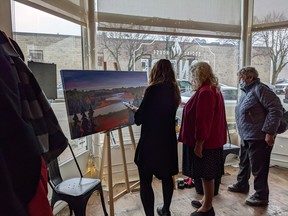 People gather inside Paisley's Bonfire on Queen Saturday for the opening of the Building Bridges gallery where eleven pieces of art inspired by the stories of local seniors and shared in podcast form by the Arran-Elderslie Youth organization are now on display. Photo supplied.
