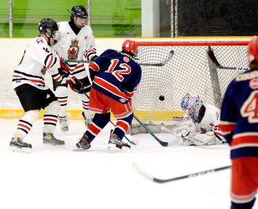 Despite being covered by two members of the Legionnaires, Porcupine Gold Kings forward Connor Lamothe deposits a shot into the Wawa net behind goalie Joseph Huff during the second period of a round-robin contest at the Carlo Cattarello Arena on Saturday. The Gold Kings went on to blank the Legionnaires 7-0 in the contest, but the NOHA U18 ‘A’ Tournament of Champions title game between the two teams on Sunday proved much closer, with the hosts winning 3-2. THOMAS PERRY/THE DAILY PRESS