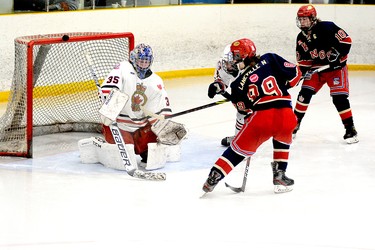 Nolan Laneville, of the Porcupine Gold Kings, rings a shot off the crossbar behind Wawa Legionnaires goalie Joseph Huff as teammate Matthew Stinson looks on during the third period of a round-robin contest at the Carlo Cattarello Arena on Saturday. The Gold Kings blanked the Legionnaires 7-0 in the contest, but had a much harder time in the title game at the NOHA U18 ‘A’ Tournament of Champions on Sunday, earning a 3-2 victory over the Wawa squad. THOMAS PERRY/THE DAILY PRESS