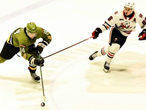 Dalyn Wakely of the North Bay Battalion advances the puck against Danil Gushchin of the visiting Niagara IceDogs in their Ontario Hockey League game Thursday night. Each scored a goal, with Wakely's the winner in a 4-1 decision.
Sean Ryan Photo