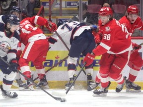 Soo Greyhounds forward Jordan D’Intino and Saginaw Spirit defender Mitchell Smith battle for space in the Spirit zone during the first period of OHL action at the GFL Memorial Gardens on Friday night. After dropping a 2-1 decision to the Spirit on Tuesday, the Hounds responded with a 9-3 victory over the Spirit.