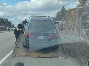 A vehicle is towed from the side of Highway 69 on Monday after its driver was charged with excessive speed.