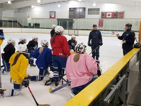 Sudbury Lady Wolves U18 A players listen to their coaches during a practice at Cambrian Arena in Sudbury, Ontario on Monday, March 4, 2022.