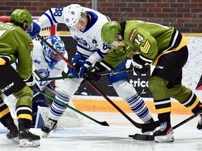 Liam Arnsby and Dalyn Wakely of the North Bay Battalion apply paired pressure to Ole Bjorgvik-Holm of the visiting Mississauga Steelheads as goaltender Roman Basran remains at the ready in Ontario Hockey League action Thursday night. The teams completed their season series.
Sean Ryan Photo