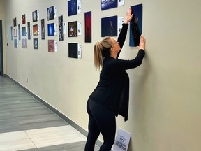 Susie O'Connor setting up the photo exhibit at the Energy Centre. Submitted.