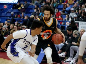 Jeremy Harris (5) of the Sudbury Five handles the ball while Chad Frazier (2) of the KW Titans defends during National Basketball League of Canada action at Sudbury Community Arena in Sudbury, Ontario on Saturday, April 9, 2022.