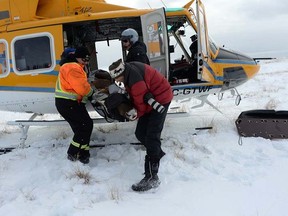 Crews lift one of the six caribou from Michipicoten island onto Caribou Island during the winter of 2018. Photo Provided