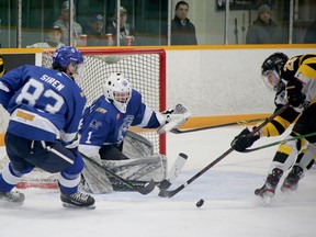 Greater Sudbury Cubs goaltender Joel Rainville (1) makes a save on Soo Eagles forward Zachary Briskey (25) while Cubs defenceman Graeme Siren (83) defends during NOJHL West semifinal action at Gerry McCrory Countryside Sports Complex in Sudbury, Ontario on Tuesday, April 12, 2022.