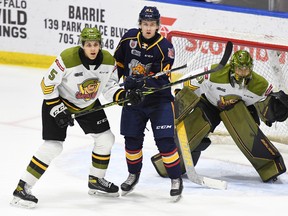 Tnias Mathurin and goaltender Dom DiVincentiis of the North Bay Battalion monitor Evan Vierling in a 6-1 road win over the Barrie Colts in Ontario Hockey League action last Saturday night. The Troops complete their home schedule against the Oshawa Generals at 7 p.m. Thursday.
Sean Ryan Photo