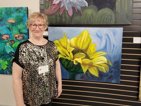 Liz Ekstrom displays some of her best paintings at the Spring Fling Art Show at the Leduc Arts Foundry, April 9. (Dillon Giancola)