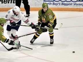 Mitchell Russell and Brandon Coe of the North Bay Battalion compete for the puck with Dawson McKinney and Mathew Hill of the Oshawa Generals in Ontario Hockey League action Thursday night. The Troops completed their 34-game home schedule.
Sean Ryan Photo