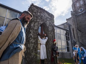 St. Thomas' Anglican Church congregation members reenact the crucifixion of Jesus Christ during a special Good Friday mass held on the grounds of their church in Belleville, Ontario. ALEX FILIPE