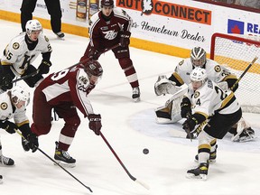 Kingston Frontenacs, from left, Paul Ludwinski, Ben Roger and Thomas Budnick battle for the puck in front of goaltender Aidan Spooner with Peterborough Petes Sam Alfano, left, and Chase Stillman during Ontario Hockey League action in Peterborough on Sunday.