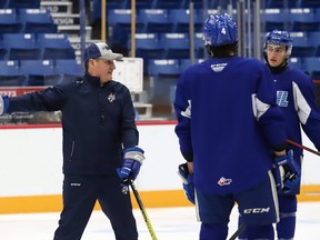 Associate coach Darryl Moxam gives instructions to Sudbury Wolves defencemen Jacob Holmes (4) and Andre Anania (78) during a practice at the Sudbury Community Arena in Sudbury, Ont. on Thursday September 30, 2021.
