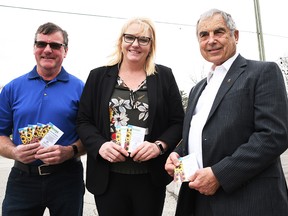 Members of the Rotary Club of Chatham Sunrise are calling on the community to make a $5 donation in exchange for a packet of sunflower seeds. The funds will support humanitarian efforts in Ukraine. Shown here near Grand Avenue West in Chatham are Rotarians Roger McRae, Leigh-Anne Perrin and project chair Paul Roy on April 13, 2022. (Tom Morrison/Chatham This Week)