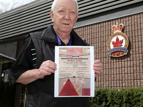 Allan Jones, president of Royal Canadian Legion Branch 560 at 734 Montreal St. in Kingston, holds a poster from an anti-vaccination and anti-mask group that plans to hold a protest in front of the branch on Saturday.
