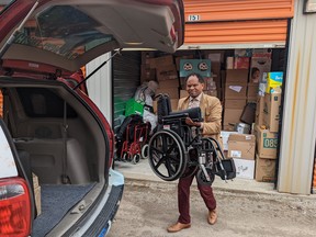 Multicultural Association of Perth Huron executive director Dr. Gezahgn Wordofa loads a wheelchair in the back of the association's van. The wheelchair, along with a pile of other donated household and personal items, were delivered to Ukrainian refugees in the Ukrainian border city of Lviv recently after a small group of association volunteers travelled to Poland and Ukraine to help refugees with filling out the immigration paperwork they need to resettle in Huron, Perth, Oxford and Middlesex counties here in Canada. Galen Simmons/The Beacon Herald/Postmedia Network