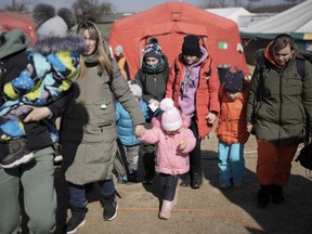 Refugees living in the Ukrainian border city of Lviv line up to board buses to Warsaw, Poland so they can fill out immigration paperwork at the Canadian Embassy there. Submitted photo