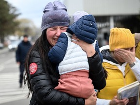 A Ukrainian refugee cradles her child as she arrives at the Siret border crossing between Romania and Ukraine earlier this week. DANIEL MIHAILESCU/AFP via Getty Images