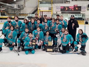 Players and staff from the 2021-22 Nickel City U13 A Sharks celebrate their NOHA championship.