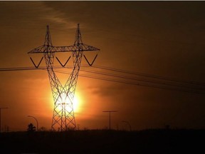 The sun sets as the sky gives off a redish glow behind power lines along the Anthony Henday Drive. in Edmonton. ED KAISER/Postmedia