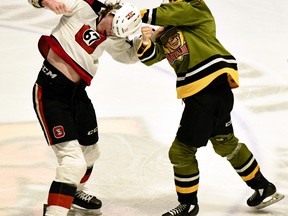 Liam Arnsby of the North Bay Battalion lands a left to Derek Smyth of the visiting Ottawa 67's in a second-period fight in their Ontario Hockey League first-round playoff game Saturday night. The series resumes Monday night at Ottawa.
Sean Ryan Photo