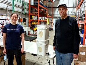 Laura Garrioch, an emergency programs officer with GlobalMedic, and Walt Bathe, chairman of the Rotary Club of Stratford's Aquabox project, show what a fully assembled Aquabox water-filtration system looks like once they are delivered to people living in disaster zones around the world.  Roughly 40 Rotary volunteers gathered in the Jutzi Water Technologies warehouse in Stratford Saturday morning to pre-fabricate and box all the pieces needed for more than 500 Aquabox kits that will be stored in Toronto and ultimately delivered to people living in disaster zones who don't have access to clean water by disaster-relief organization, GlobalMedic.  Galen Simmons/The Beacon Herald/Postmedia Network