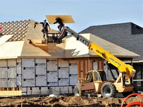 Waterford Coun. Kim Huffman said many in Ward 7 are concerned about the rapid pace of development in Waterford and would like to have a high-level discussion about it with Norfolk County. Here, construction workers Friday install a roof in the Villages of Waterford subdivision in the north end of town. – Monte Sonnenberg