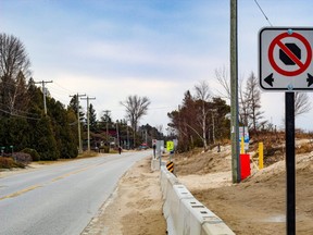 The town hopes pedestrians will walk on the beach side of temporary concrete barriers which run along the west side of Lakeshore Blvd North. The barricade is meant to prevent parking and protect people from traffic on the busy street. (Matt Bacon)