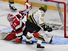Kyle Jackson of the visiting North Bay Battalion puts the puck past Ottawa 67's goaltender Max Donoso in their Ontario Hockey League first-round playoff game Wednesday night. The teams battled to a 1-1 tie through the first period.
Sean Ryan Photo