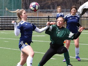 Arijana Tuttle, left, of College Notre-Dame, and Liz Uguccioni, of Lockerby Vikings, battle for the ball during girls high school soccer action at James Jerome Sports Complex in Sudbury, Ont. on Wednesday April 27, 2022.