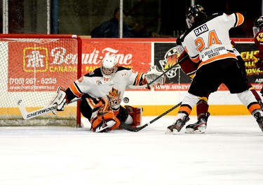 Lumberjacks goalie Liam Oxner makes a save off a shot from Timmins Rock forward Harry Clark, being checked by Hearst defender Jaden Raad, during the second period of Game 7 of the NOJHL East Division final series at the McIntyre Arena Friday night. The Lumberjacks overcame a two-goal first-period deficit to defeat the Rock 4-3 and advance to meet the West Division’s Soo Thunderbirds in teh NOJHL championship series. THOMAS PERRY/THE DAILY PRESS