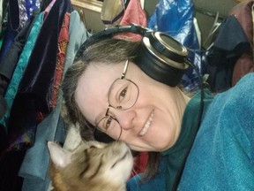 Author and voice for several novels, Nicola MacCameron in her studio with her cat. She is excited to give a presentation at the Okotoks Library on May 3rd at 6:30 p.m.
