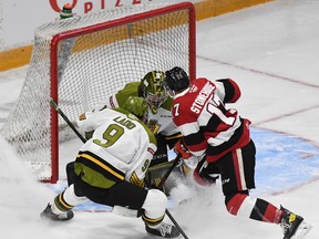Brady Stonehouse of the Ottawa 67's is met by Grayson Ladd and goaltender Joe Vrbetic at the North Bay Battalion crease Wednesday night. The visiting Troops won 3-2 to complete an Ontario Hockey League first-round playoff sweep.
Sean Ryan Photo