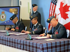 Col. Richard Jolette, left, assumes command of 22 Wing/CFB North Bay from Col. Mark Lachapelle, right, Friday, in a ceremony at the base. Maj. Gen. E.J. Kenny, commander of 1 Canadian Air Division, centre, officiated at the ceremony.
PJ Wilson/The Nugget